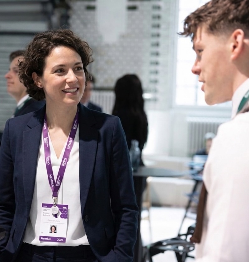 lady-with-purple-lanyard Lady wearing VenuIQ beacon at an event.